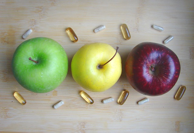 trio of apples surrounded by pills/capsules